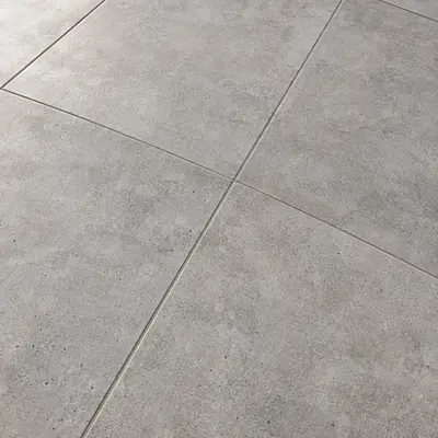 Carrelage extérieur gris à effet béton.